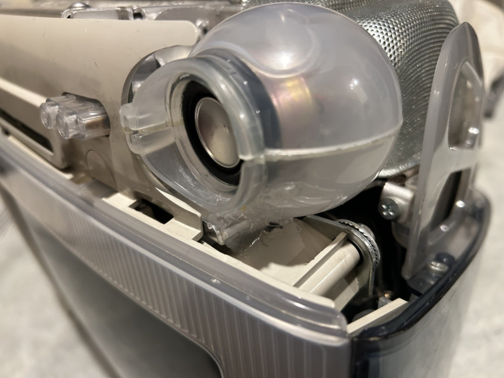 Speaker housing hot glued to iMac frame